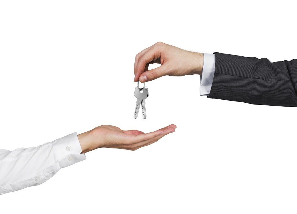 Handing over the keys when selling an auto dealership.
